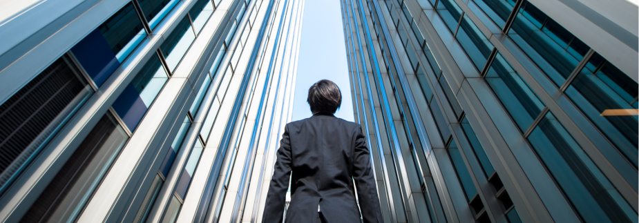 Photo of a businessman between two skyscrapers