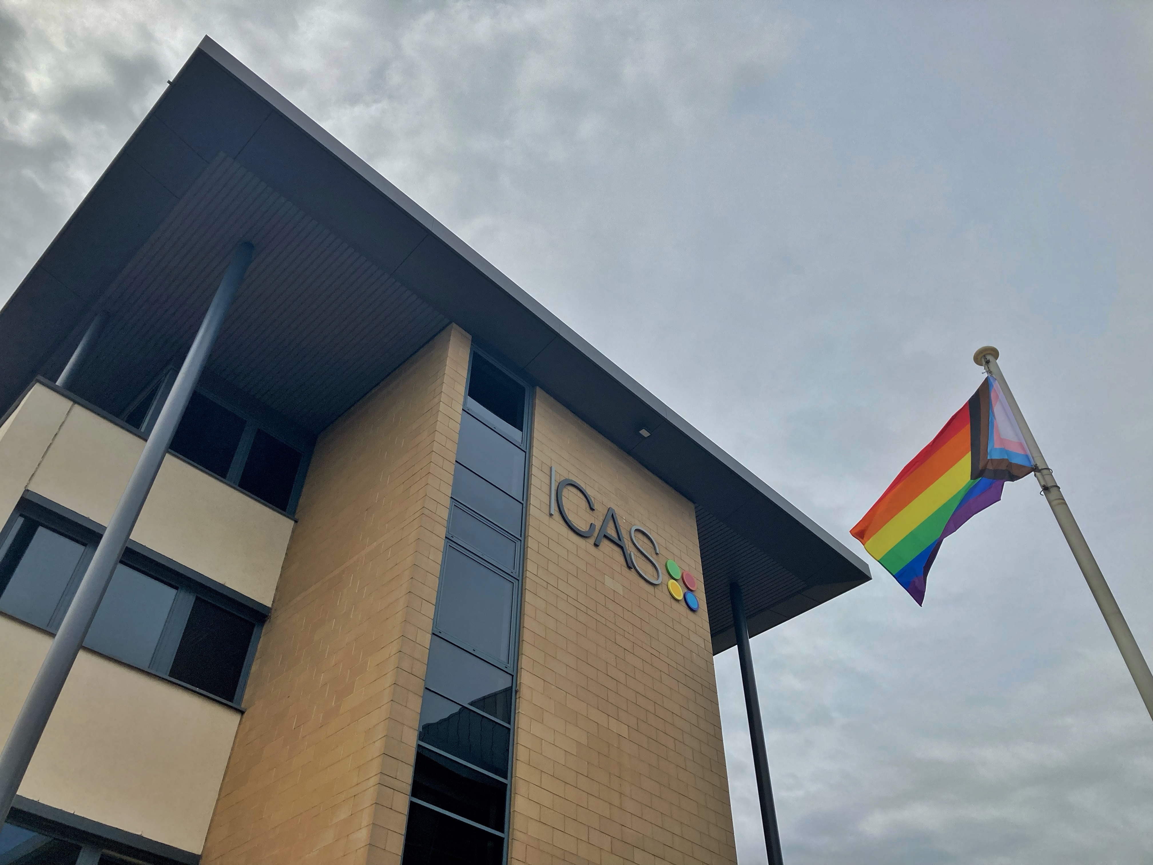 Rainbow flag flying in front of the ICAS office